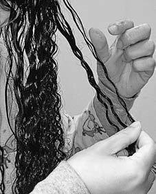 When one little curl section has been freed, run your hand down it in the direction it will be hanging.