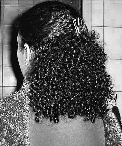 To set and define her curls after washing, applying conditioner, and combing, she says that she gently presses her fingers together as she runs her