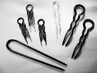 238 Curly Like Me Use from one to four pins to hold your locks in place. Pins function more as anchors than to hold back lots of loose hairs. You can decorate your bun with hair sticks.