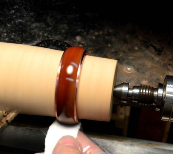 TIP: Turn down a scrap piece of wood to act as a jam chuck and place the bangle bracelet on this jam chuck to apply the CA glue finish.