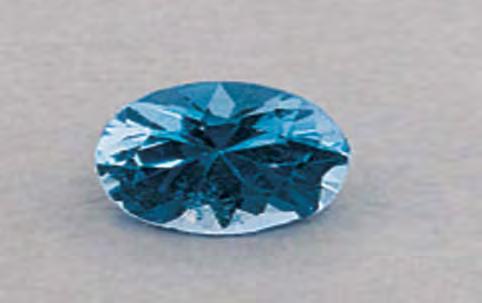 Figure 36. This 5.99 ct blue synthetic spinel contained unusual inclusions. Photo by L. Kiefert, SSEF. (determined hydrostatically) was 3.