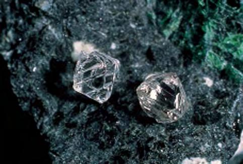 Figure 45. These gem-quality diamond crystals, which were photographed on a colorful piece of kimberlite, are from Canada s Ekati mine. Courtesy of BHP Billiton Diamonds.