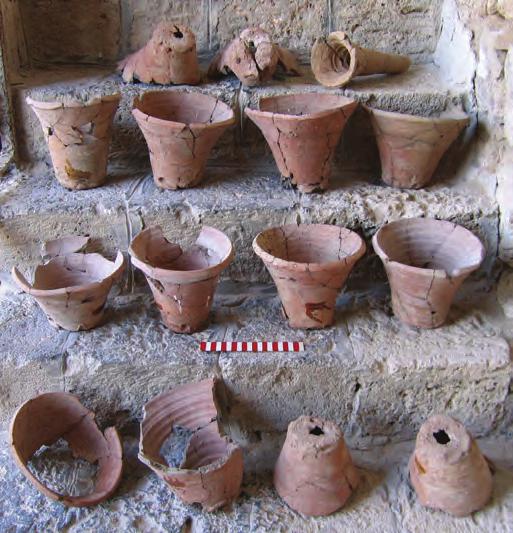 Accompanying the twenty flowerpots were a number of other examples of a unique vessel type resembling funnels, although it is unclear if they were pierced all the way through (figs. 15, 16).