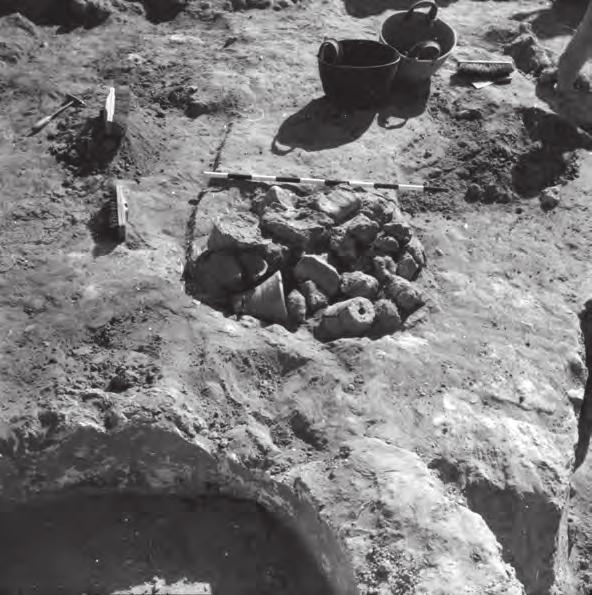 Thankfully, however, photographs still exist showing a large number of the so-called flowerpots within what appears to be an open-firing pit in an adjoining locus within the same excavation square
