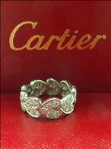 Estimate: $1,900 to $2,300 Lot: 147 A CARTIER 18K WHITE GOLD HEARTS AND SYMBOLS DIAMOND RING, continuously joint nine heart shaped fully set with circular diamonds. Individual Number 251657.
