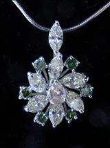 Lot: 161 H0915/103 A 18K WHITE GOLD FLOWER DESIGNED DIAMOND PENDANT, centre set with a pear brilliant diamond and surrounded by 7 marquise diamonds (3.