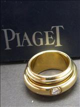 Lot: 214 6MJYJ6 A PIAGET 18K YELLOW GOLD RING, broad band designed with centre a rotatable ring, embedded with round diamond, Individual Number A50061. Weight 18.33gm.