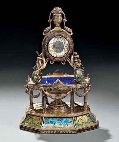 century, the urn-form finial atop a circular case supported by four scrolled arms adorned with cherubs,