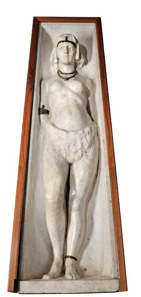 250 250 Egyptian Revival White Granite and Bronze Figure of a Woman, late 19th century, the standing figure carved in high relief and set within a tapered frame, wearing a headdress, loincloth, and
