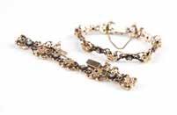 AS- 92 A pair of gold and gem-set bracelets Two tested 14K gold floral and open sectional link bracelets set with alternating sapphires, rubies and silver-topped gold with diamond centers, 7'', 46.