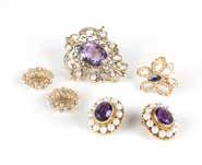 3 gms gross, 10 pcs, est: $400/600 147 A group of gem, seed pearl and gold jewelry Including a pair of 18K gold, amethyst and seed pearl clip-back earrings, a 14K gold pendant/brooch, a pair