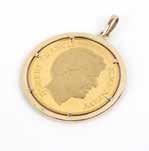 182 A gold Kennedy coin in gold bezel pendant A high karat gold Robert Francis Kennedy gold commemorative coin set in 18K gold bezel pendant, 2 1/4'', 89.