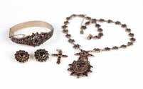 Your bid indicates 251 A collection of garnet, gold and metal jewelry A gold plated bangle (a few garnets missing), a pendant necklace, a pair of clip-earrings with 14K gold clip backs and a 10K gold
