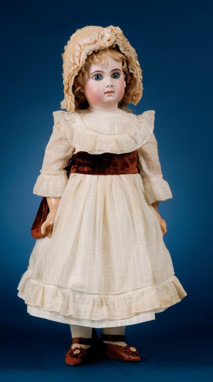 Jumeau, Medaille d Or, Paris on the back, in checked white cotton dress, cotton and wool undergarments, knitted stockings, brown kid shoes and straw hat trimmed with flowers and feathers, ht.