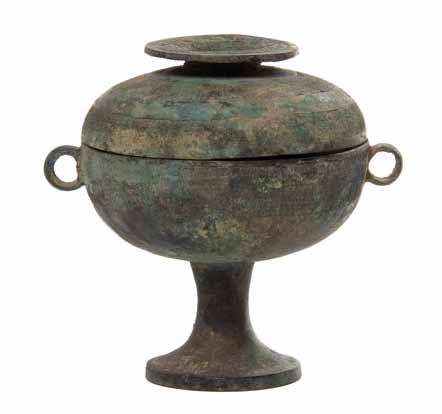 291 290* An Archaistic Bronze Dou Vessel the circular covered food vessel raised on a pedestal foot and flanked by loop handles, with a disc-form finial elevated above the domed cover, having relief
