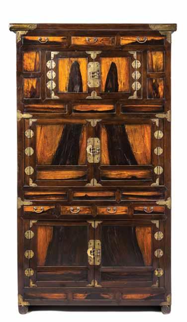335 328 329 328* A Korean Persimmon Wood Chest of Drawers, having shaped metal mounts, with three drawers above two sets of doors, the lower register with four drawers above double cabinet doors.