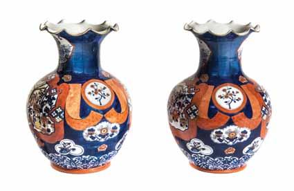 345* A Pair of Japanese Porcelain Vases, each of a squat bottle form with ruffled rim, depicting phoenixes and peonies reserved on a patterned ground. Height 24 3/4 inches.