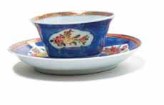 25* A Chinese Export Cup and Saucer, each centered with a squirrel and with grape and vine border, the exterior of the cup with painted petal decoration, the saucer with stem feet.