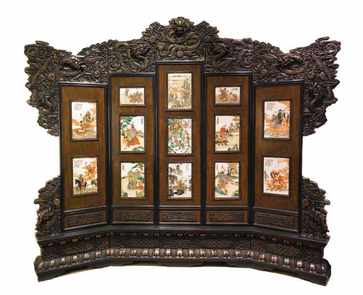 116* A Chinese Hardwood and Porcelain Floorscreen, having a relief carved crest, depicting seven dragons pursuing flaming pearls, over five panels with inset polychrome enamel porcelain plaques,
