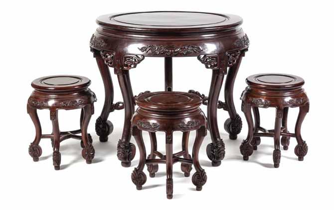 137 137* A Chinese Carved Wood Table and Chairs, the table having a round top above relief carved apron and pierced spandrels, raised on five carved legs, with