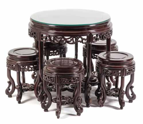 $500-700 138* A Chinese Hardwood Tea Table Suite, comprising a table and five chairs, the table having a circular top with fitted glass, over the pierced