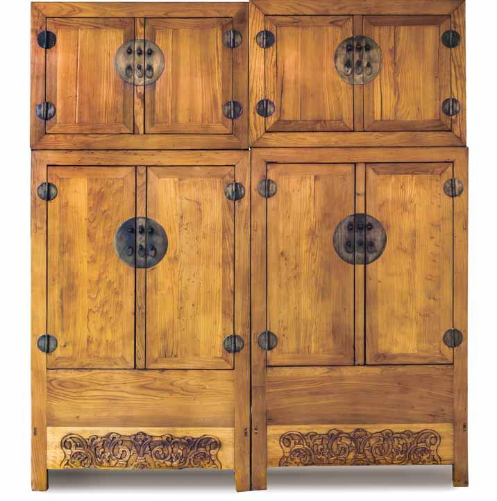 168* A Pair of Chinese Wood Compound Cabinets, the wood of a honeyed, gold hue, each section having double doors with circular lockplates and hinges, the lower sections opening to reveal shelves and