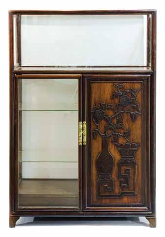 $300-500 197* A Chinese Wood and Glass Display Cabinet, the rectangular top having five glass sides, two of which form hinged doors at the sides, over a wood paneled door with relief carved vessels