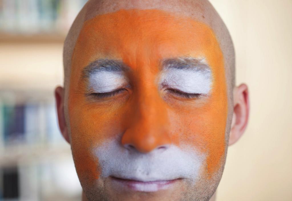 Then sponge the top of their face with orange paint. Apply white detailing with a brush.