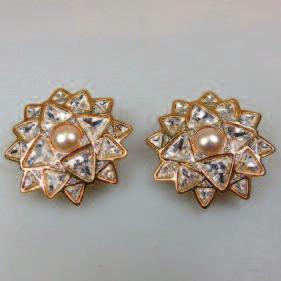 pair of gold tone metal clip earrings set with clear rhinestones