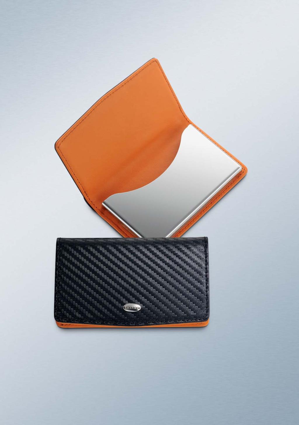 CARBON FIBRE & ORANGE LEATHER BUSINESS CARD CASE A masculine, elegant and contemporary reimagining of a Dalvey classic, this business card case combines dramatically textured