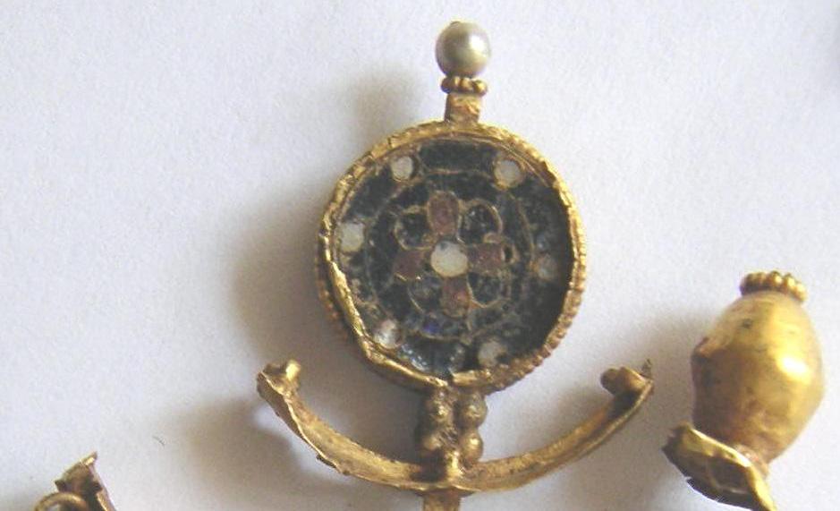 Fig. 20. Gold earcap or decoration with pearls and cloisonné enamel found in SE Egypt near the Red Sea they are known as the mines of Cleopatra, but the mineral is known also in ancient India.