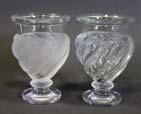 150 LALIQUE ERMENONVILLE URN PAIR -pedestal urns with twisted leaf design, one urn is frosted glass and the other is clear. Both signed to the base.