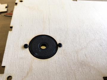 Put the piezo into the pre-cut hole from the inside of the back panel Insert the two