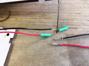 Connect the piezo's red and black wires to two lengths of jumper wires by sliding the