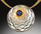 Second Place: Adam Neeley of Adam Neeley Designs in Laguna Beach, CA, for his Revealing Beauty pendant in 14k 2nd Place Professional palladium white gold and 14k yellow gold, with a blue sapphire.