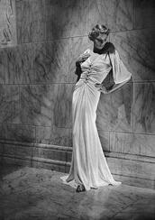 silhouette: long and slim with flared hem (think mermaid) Hemlines were dropped back down to the