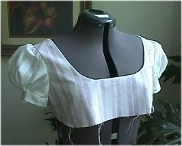 D. Pull gathers to fit. Stitch. Clip curves, turn sleeve inside out and press. Set aside. Bodice with sleeves.