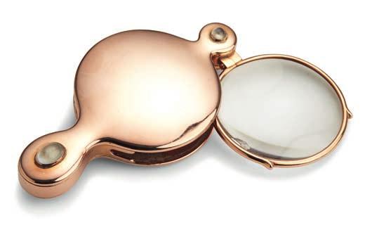 834 834 RUSSIAN GOLDSMITH, C. 1900 A Russian 14k gold magnifying glass, circular design with drop-shaped handle, set with two rounds and two oval cabochon-cut moonstones. Cyrillic maker's mark GK, St.