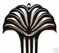 Picture 5: Hair comb showing the 'sunray' design A third type of interpretation features palm like motifs radiating out from the centre, as in example 6.