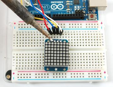 Place a 4-pin piece of header with the LONG pins down into the breadboard.