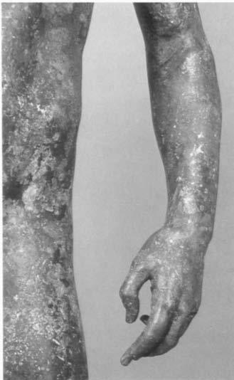 The statue's slightly bent left arm is lowered, and the elbow is cocked away from the body [FIGURE 41].