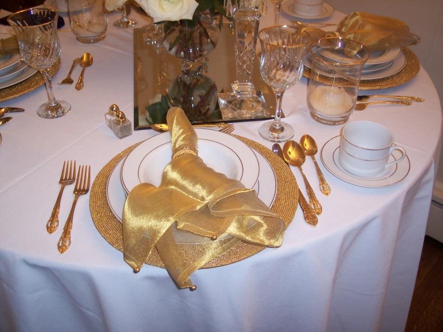 beautiful porcelain gold trimmed plate set in a gold beaded charger.