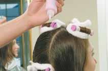 Unfasten the rod and unwind the curl about one to two turns of the rod. Do not allow the hair to become loose or completely unwound.
