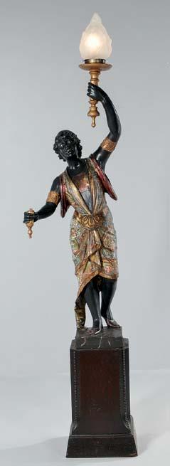 457 Painted Giltwood Blackamoor Figural Torchere, Italy, early 20th century, carved and polychrome decorated figure of a woman holding a lamp, standing on a square plinth, electrified, ht. 59 1/2, wd.