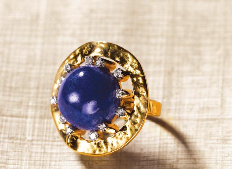 Shimmering diamonds seated in orbs of gold illuminate an azure lapis