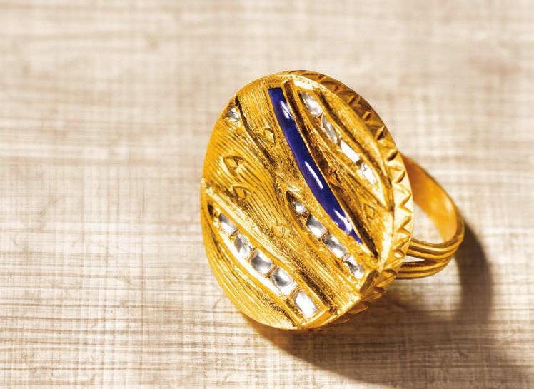 Blue enamel set in distinctly crafted gold and praised by streaks of glittering