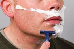 Put shaving cream into the hand and apply it to the beard in upward circular motions.