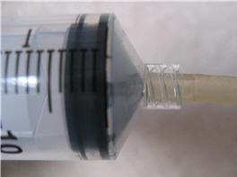 Aquarium tubing pressed on to end of syringe. 4. Here is a picture of the completed plastic bottle/syringe gas collection apparatus.
