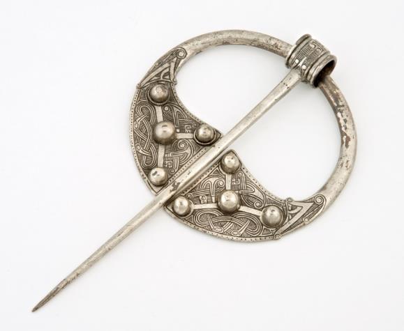 Penannular Brooch A type of dress fastener formed from a metal ring with a pin attached to it by a loop. The metal ring has a gap in it. See the picture below: Arm-ring A type of simple bracelet.