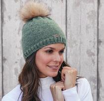 GhasB01 43 A plain knitted hat with a faux fur pom pom and diamante detail on the